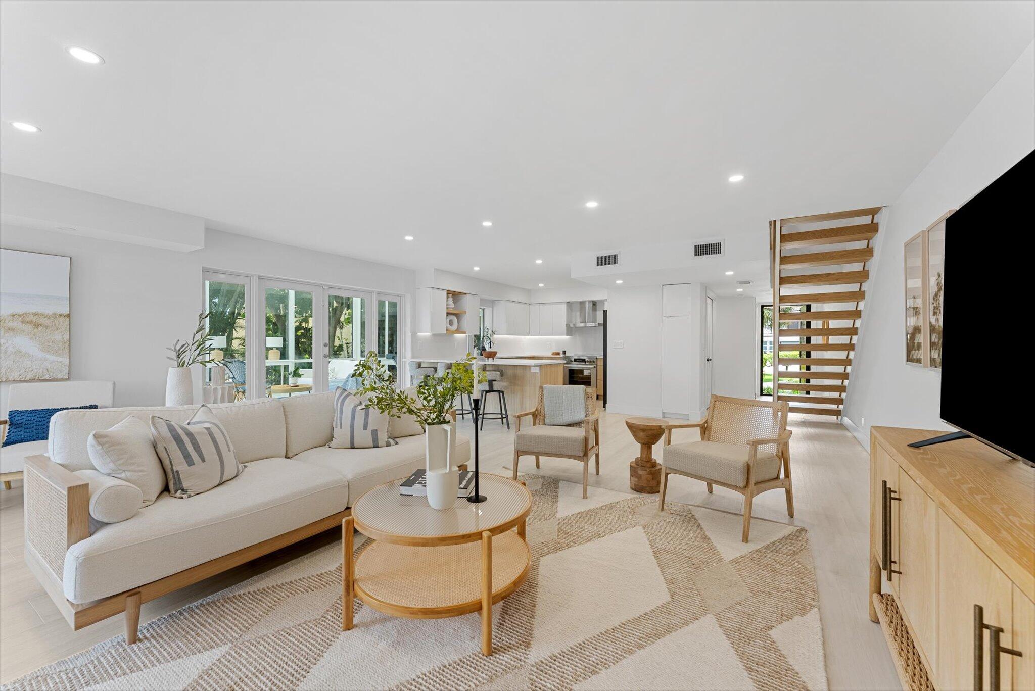 a living room with furniture flat screen tv and white walls