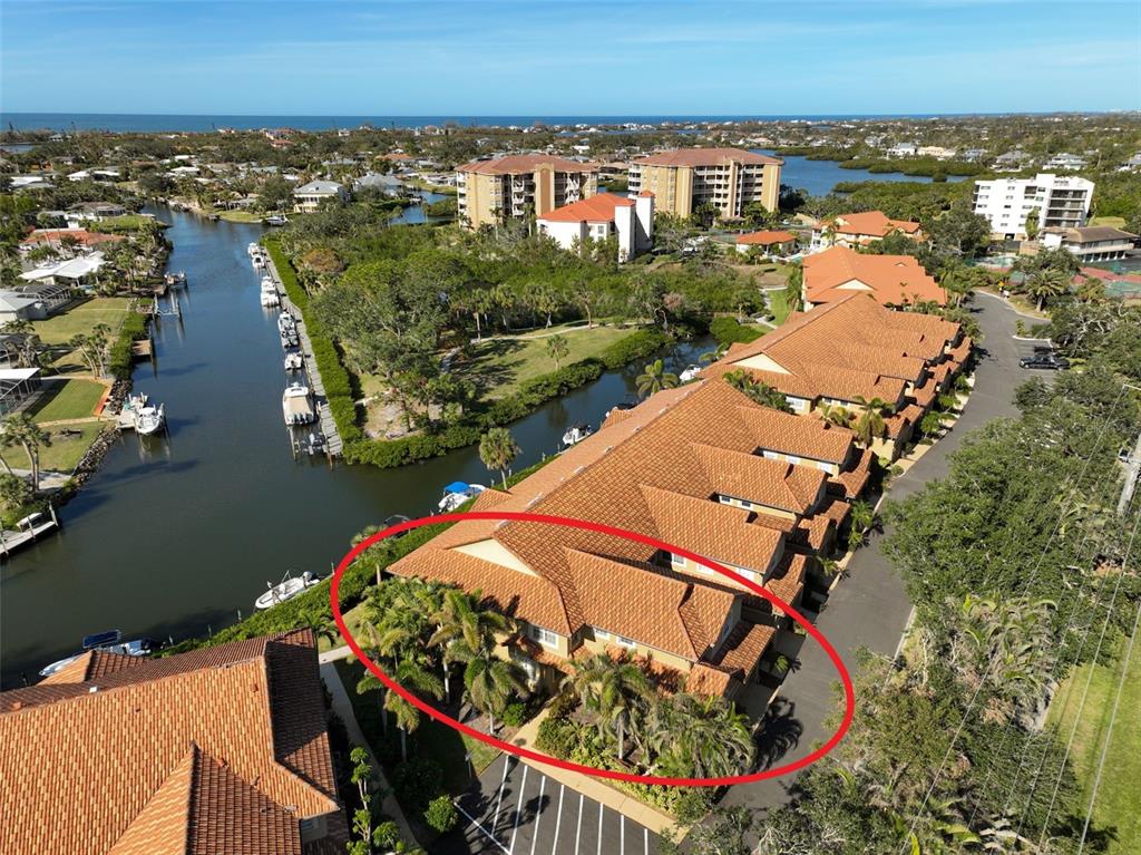 an aerial view of a house with a garden and lake view