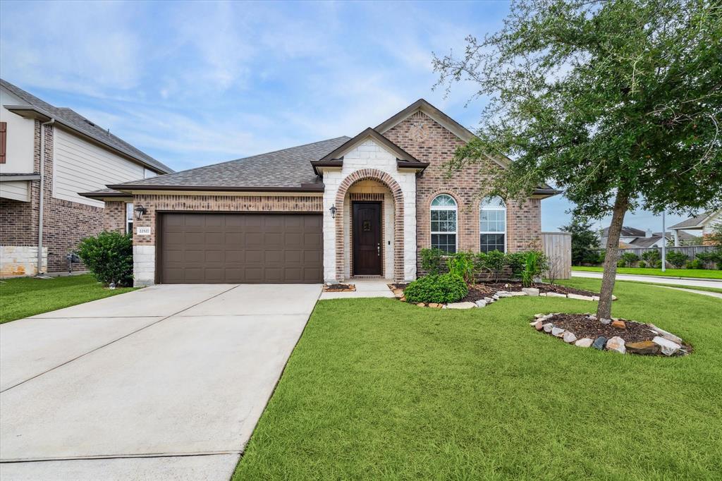 a front view of a house with a yard and garage