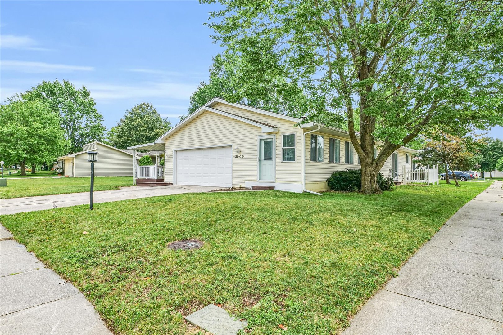 a house with green field in front of it