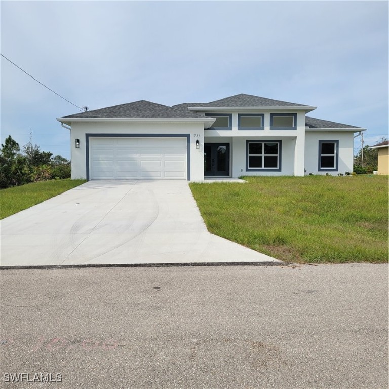 a front view of a house with a yard and garage