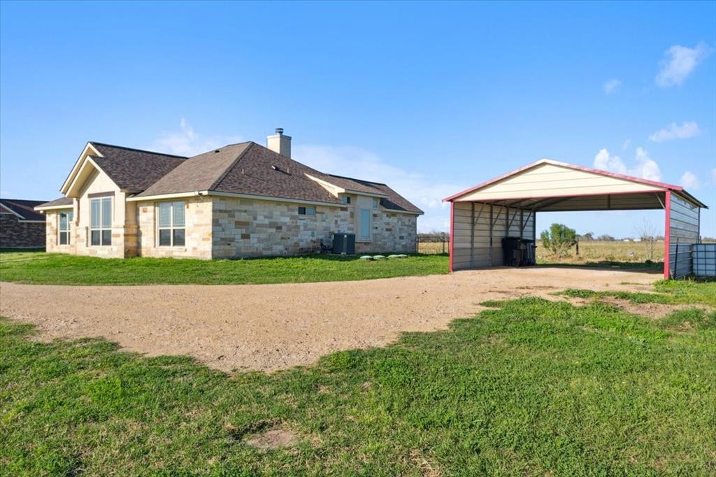 a house with green field in front of it