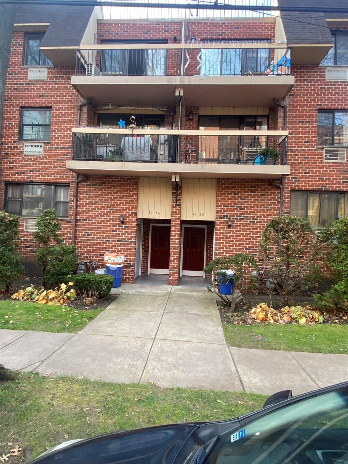 a front view of a building with garden