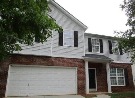 a front view of a house with a garage