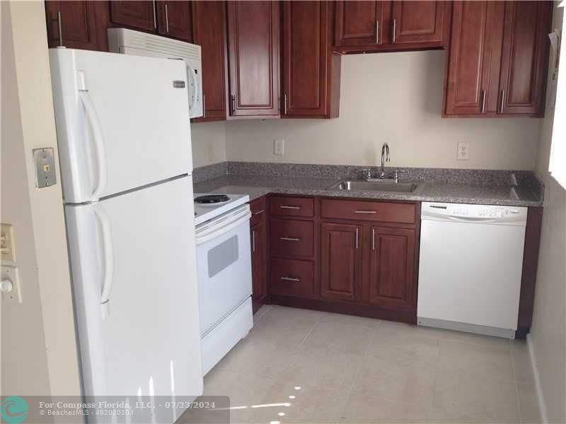 a white refrigerator freezer sitting inside of a kitchen