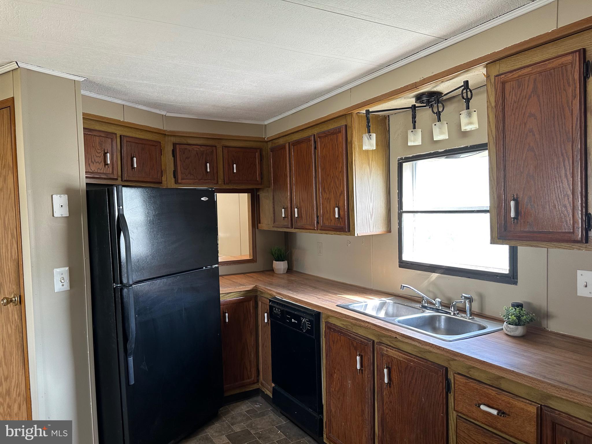 a kitchen with a refrigerator and a sink