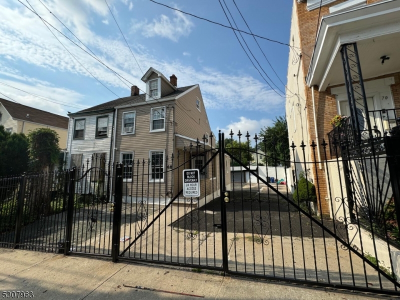 a view of a house with a iron gate