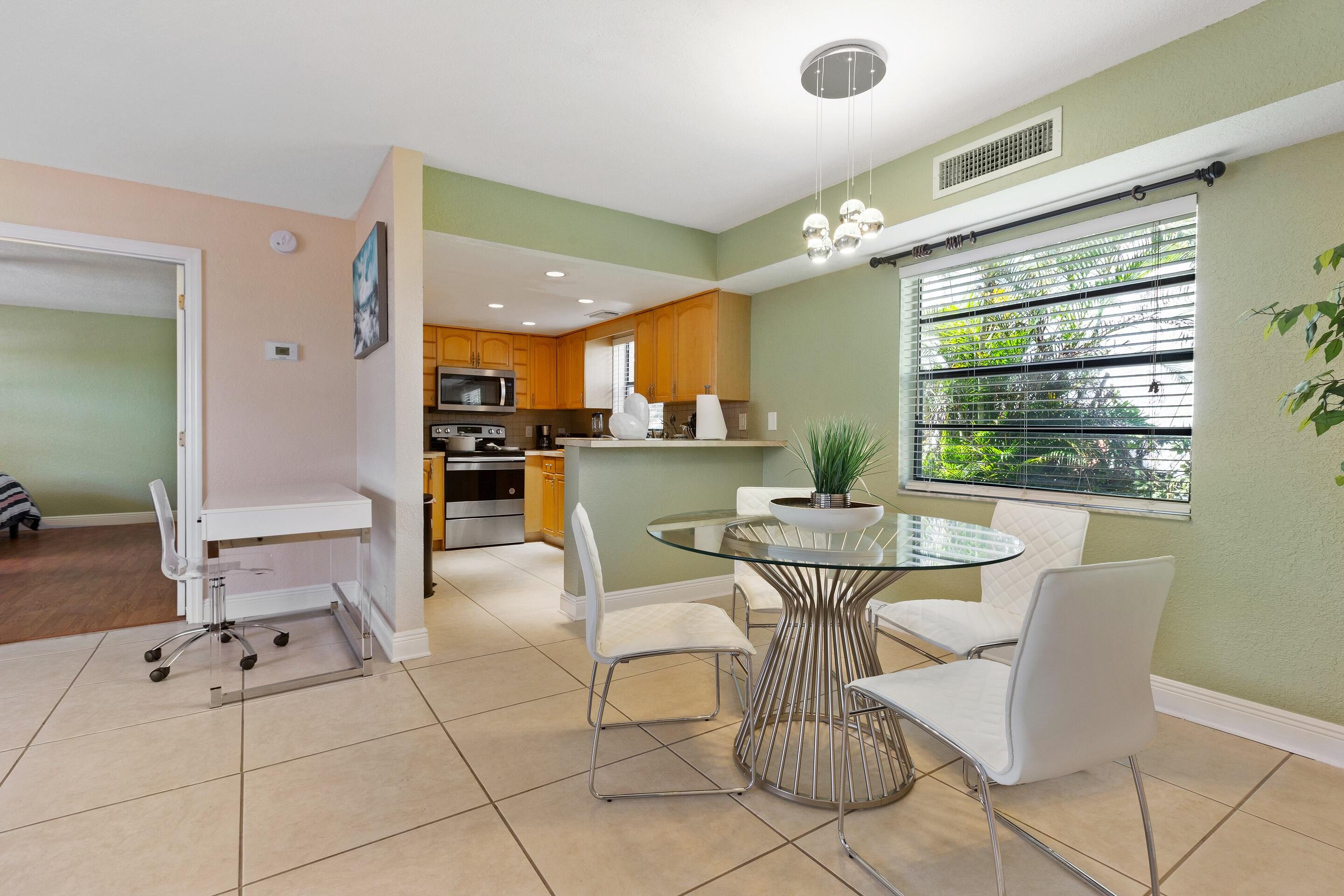 a kitchen with a table and chairs