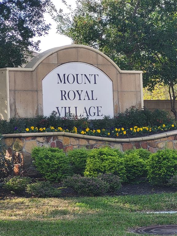 a view of a sign in a yard with potted plants