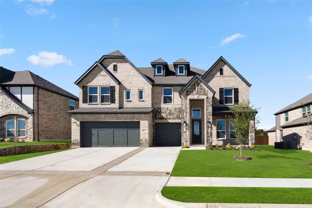 a front view of a house with a yard and garage