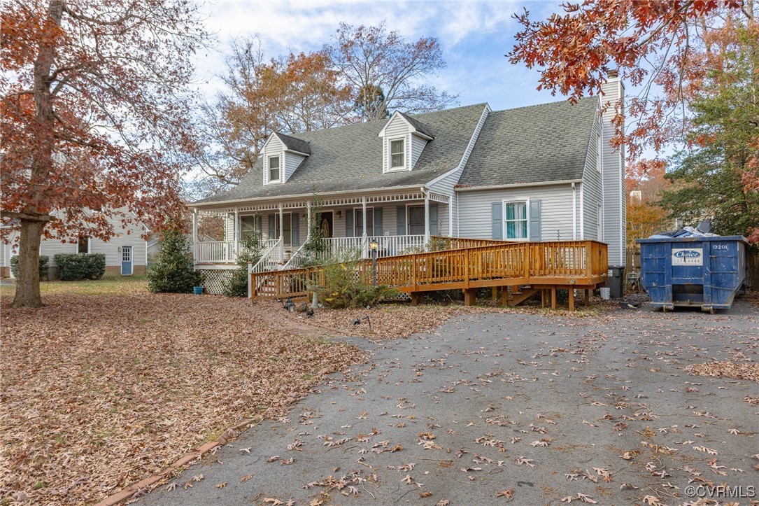 New england style home with covered porch