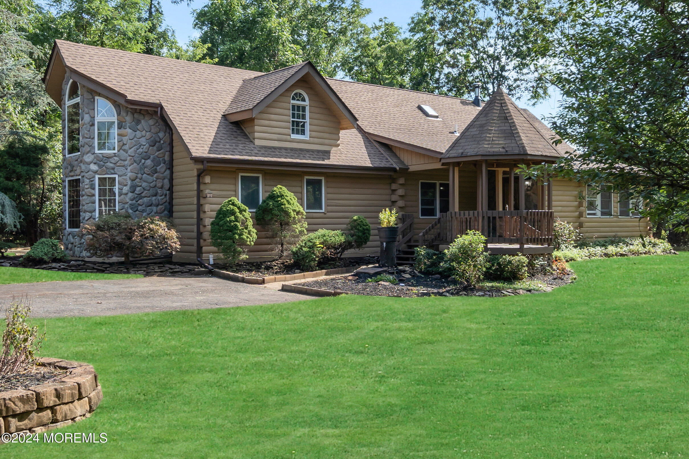 a front view of a house with a garden and plants