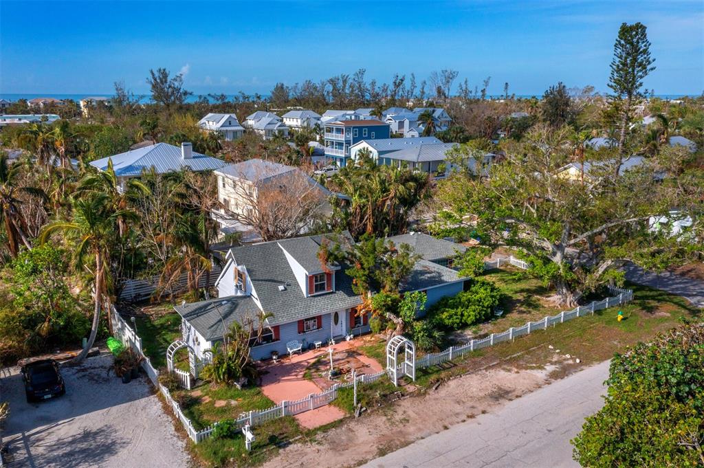 an aerial view of a house with a yard basket ball court and outdoor seating