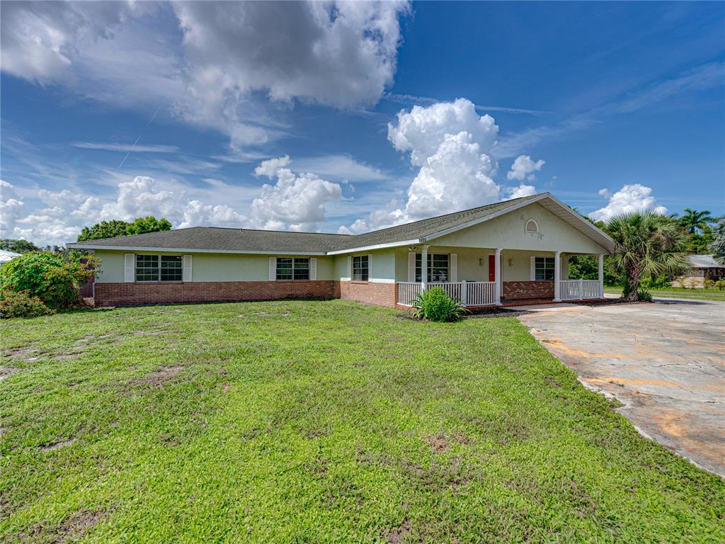 a front view of a house with a garden and porch