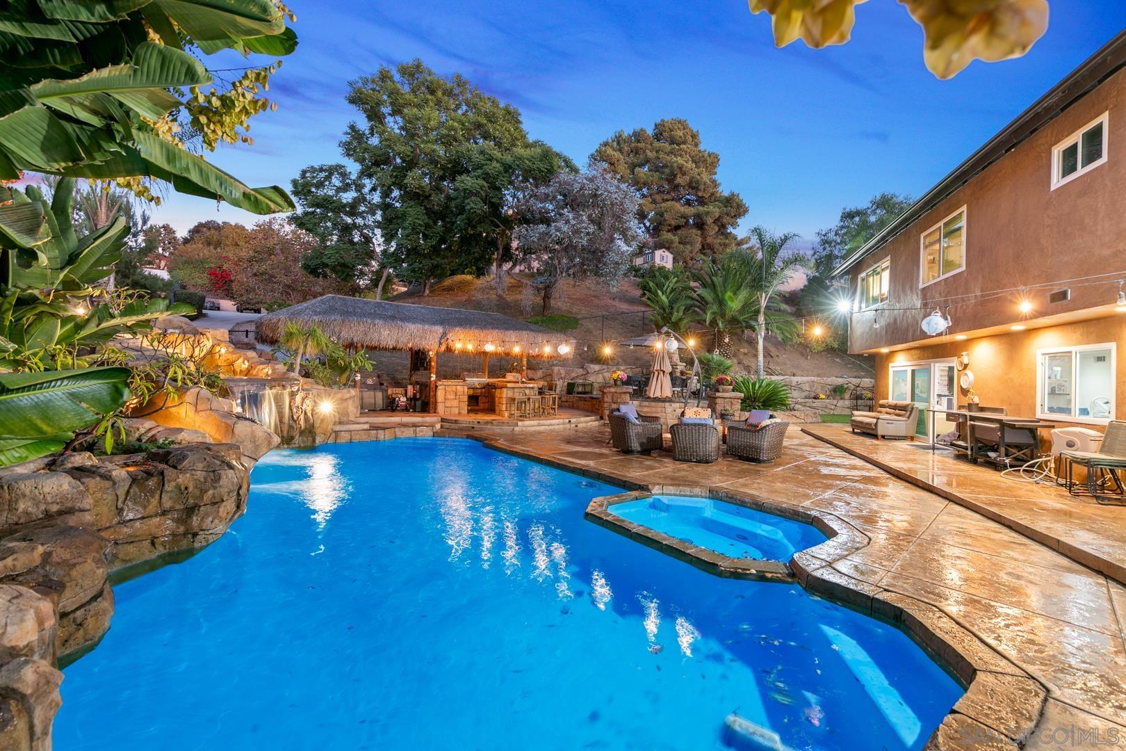 a view of a swimming pool with outdoor seating