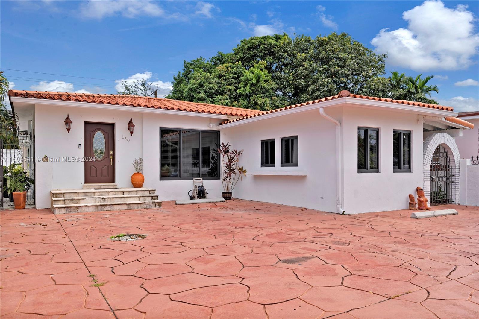 a view of a white house with a outdoor space