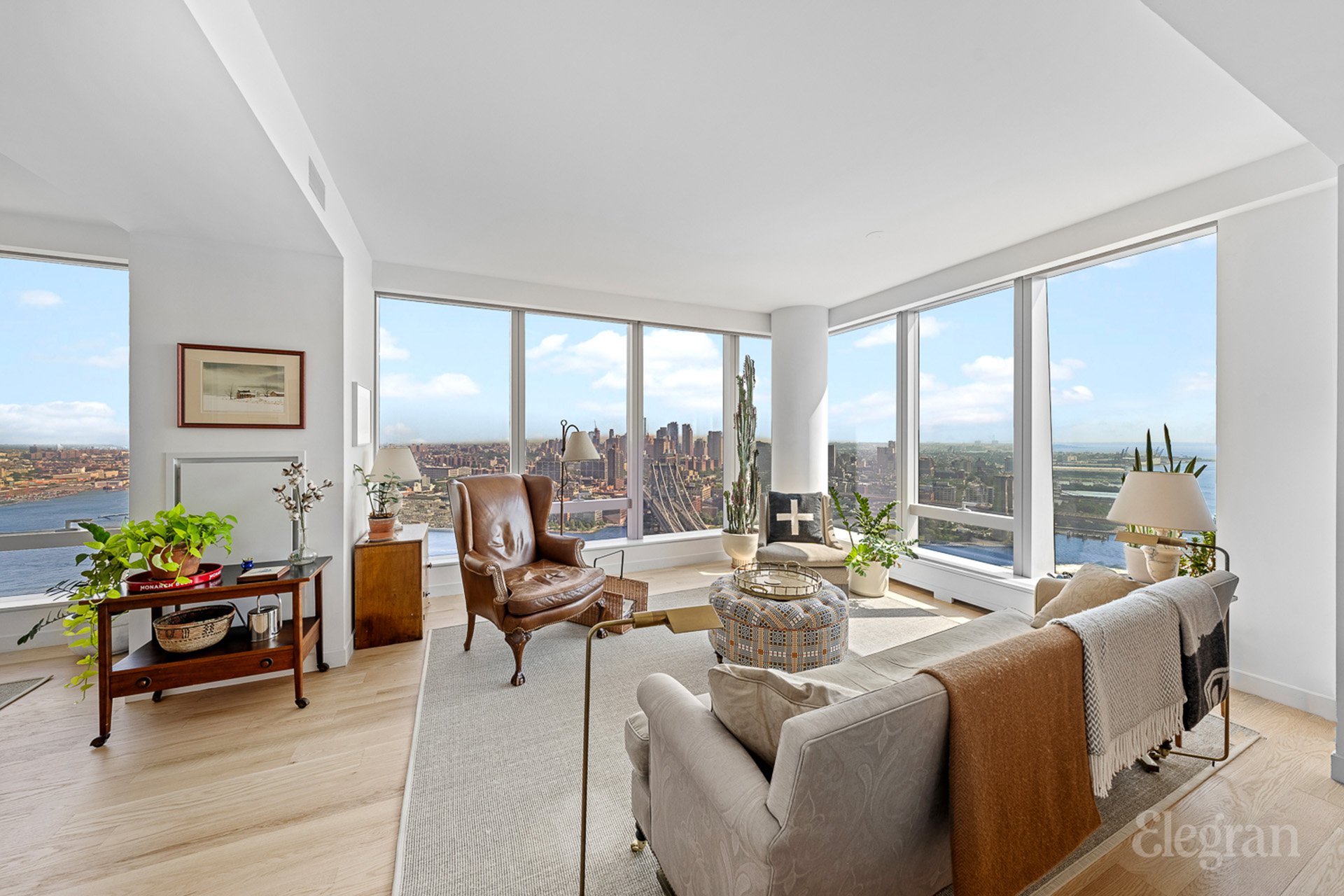 a living room with furniture and floor to ceiling windows