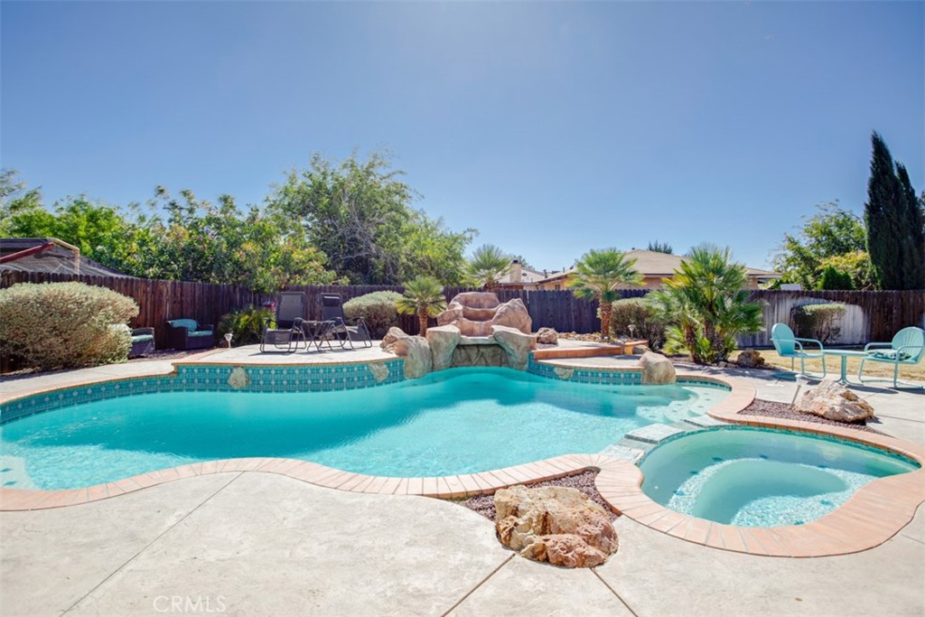 a view of a backyard with sitting area