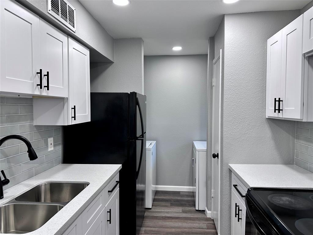 a kitchen with a refrigerator and a sink