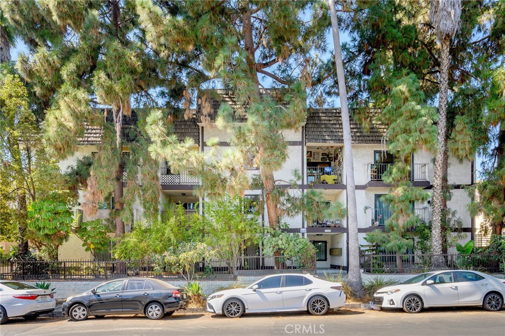 a view of cars parked in front of a brick building