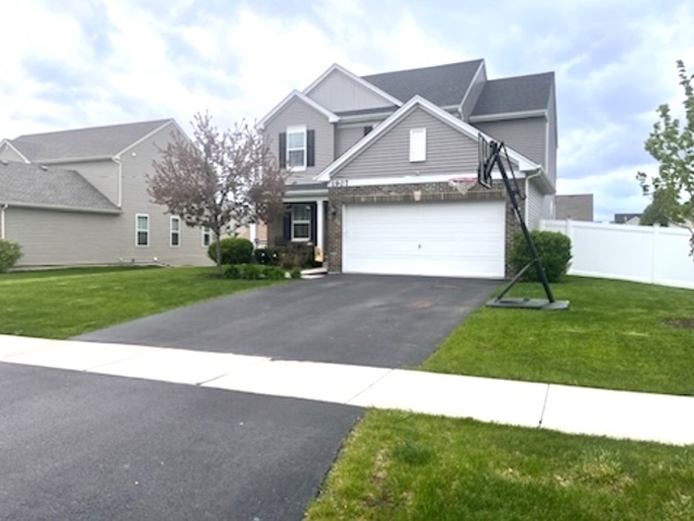 a front view of a house with a yard and garage