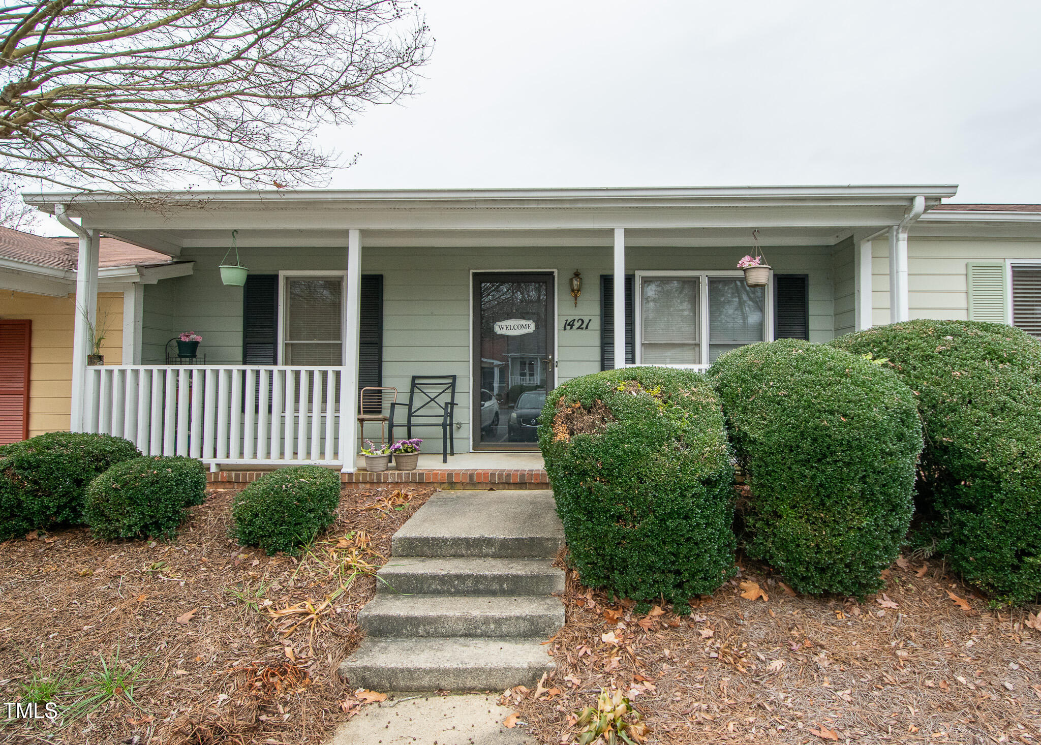 a front view of a house with a garden