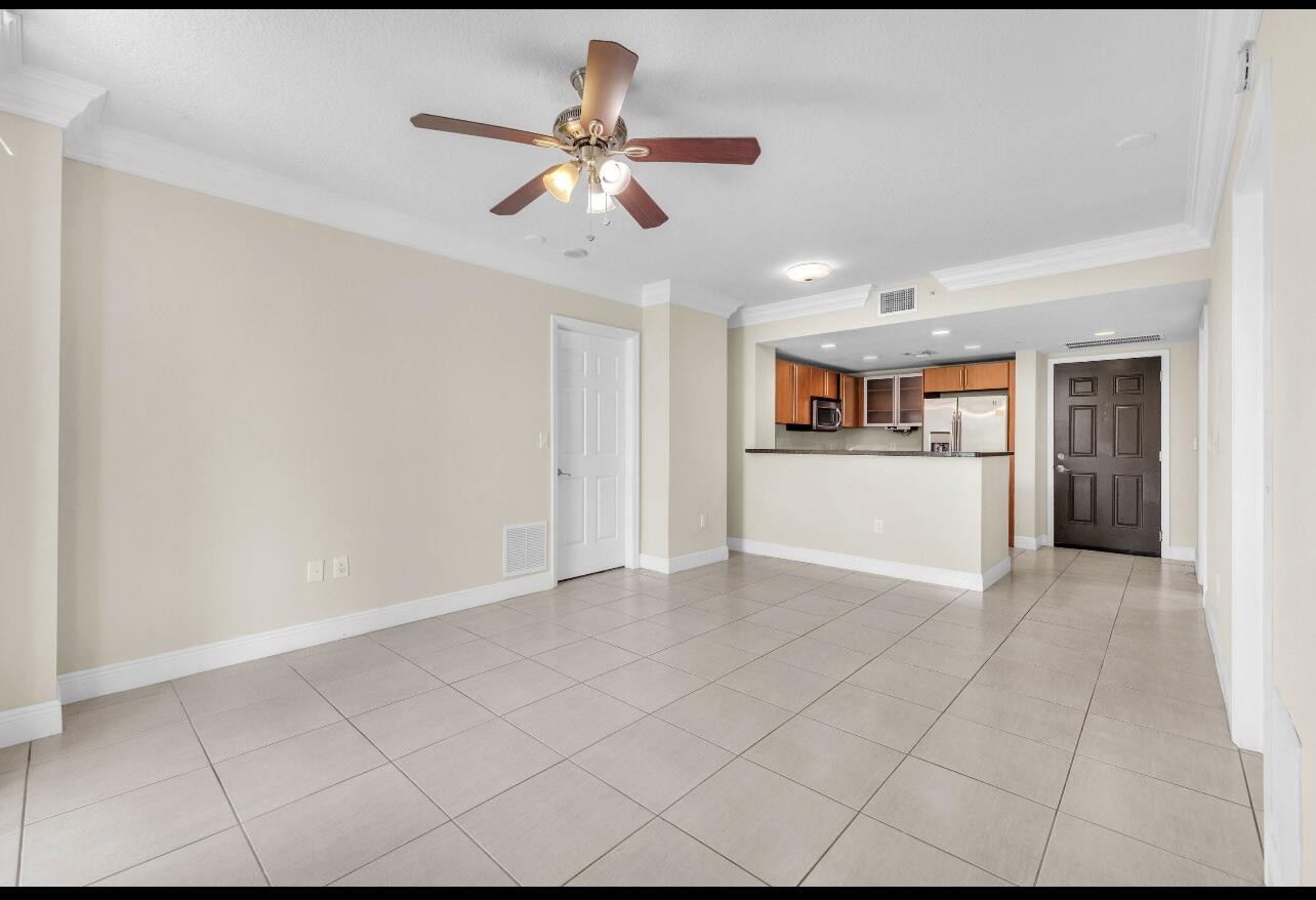 a view of a livingroom with a ceiling fan and wooden floor