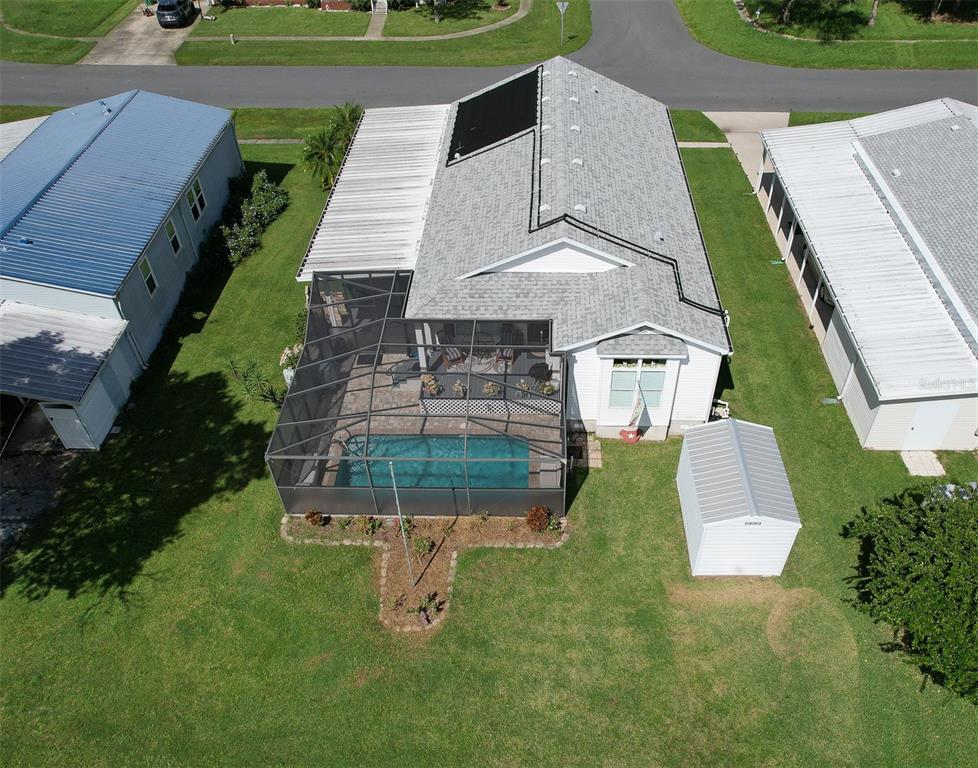 an aerial view of a house with a yard