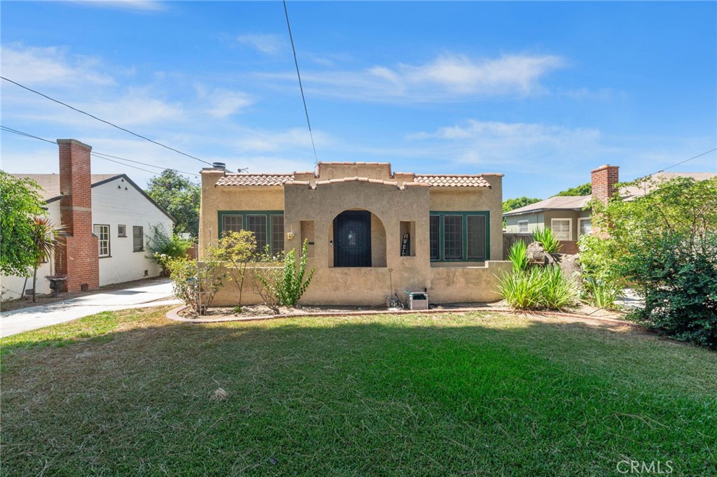 a view of a house with a yard and sitting area