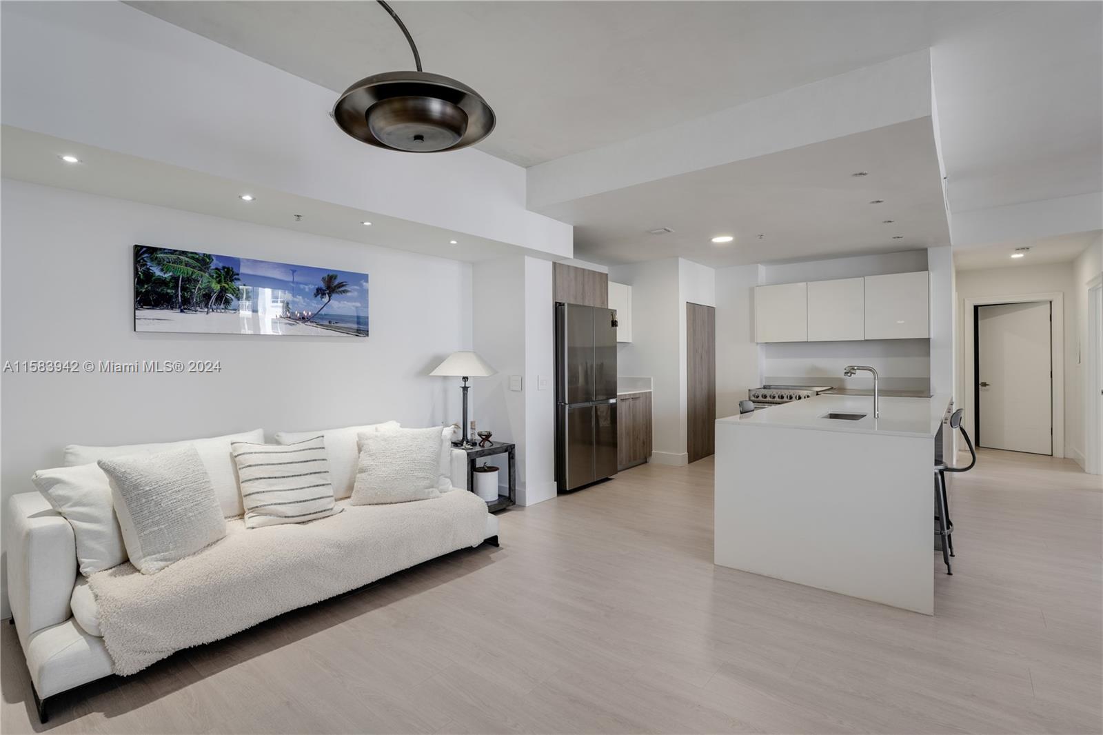 a living room with furniture and kitchen view