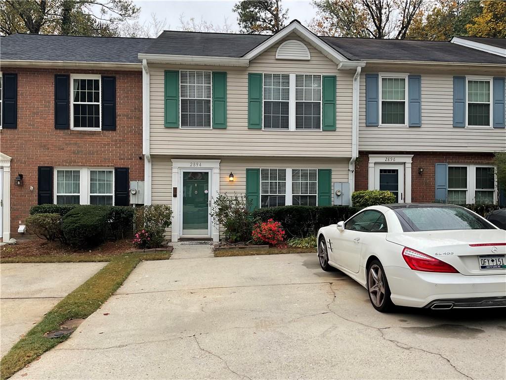 a view of a car parked in front of a brick house