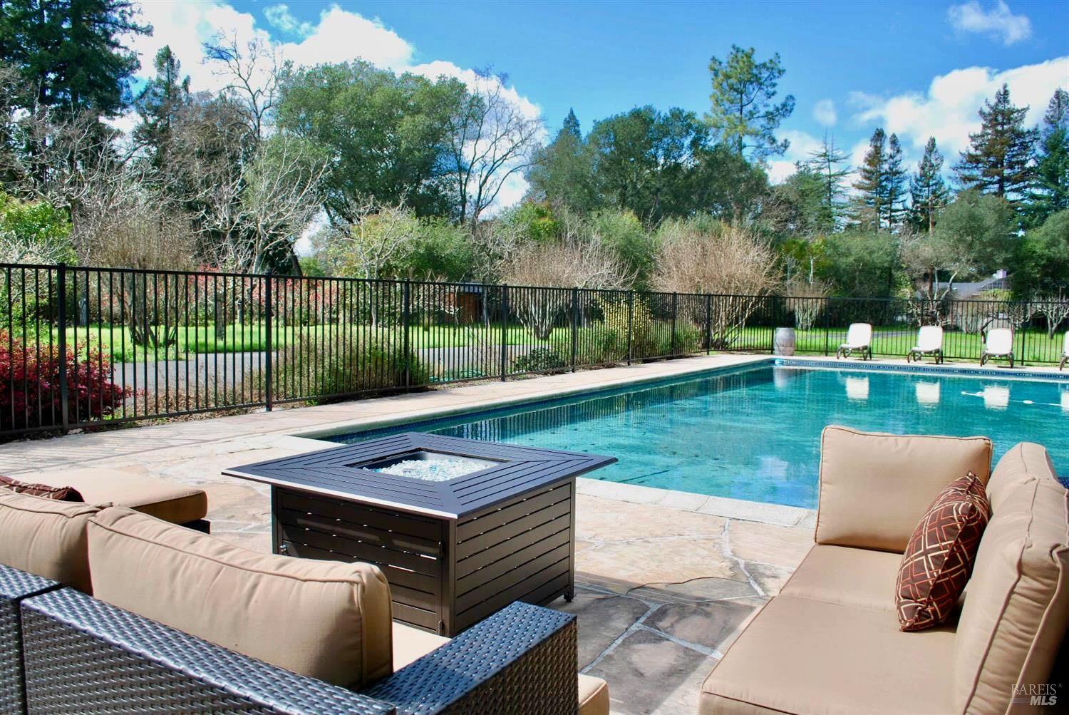 a view of a backyard with sitting area