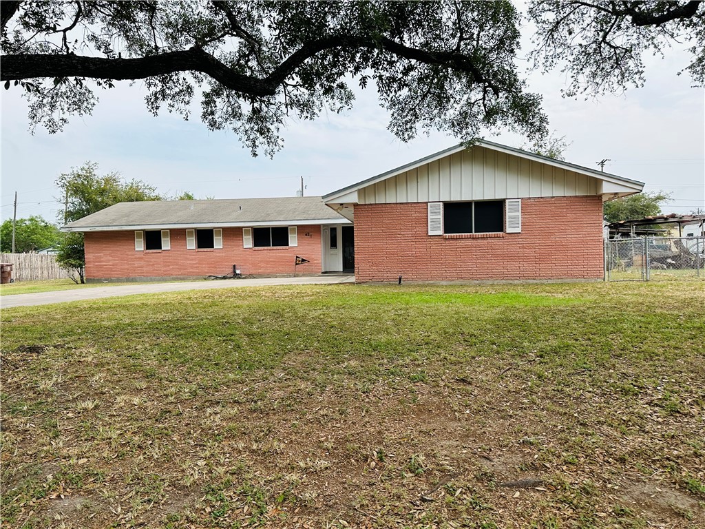 a front view of house with yard and green space