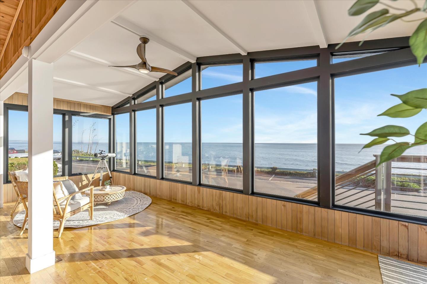 a view of living room with a floor to ceiling window and wooden floor