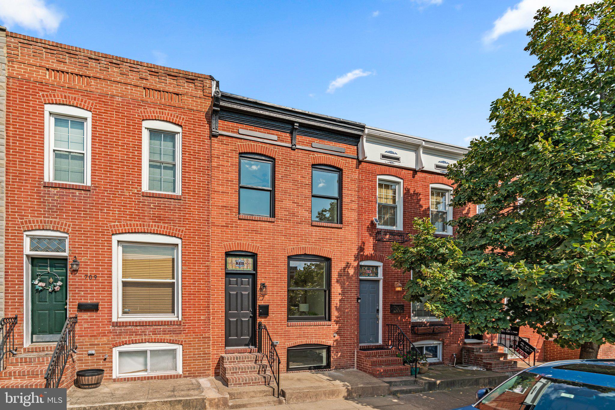 a front view of a residential apartment building with a yard