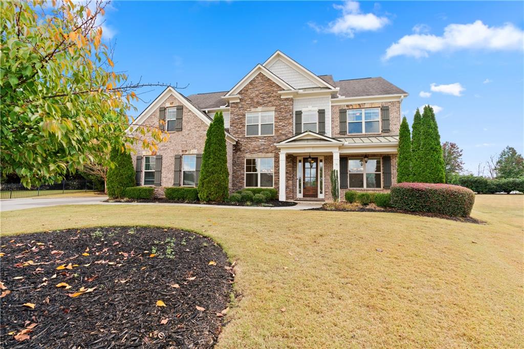 a front view of a house with a yard