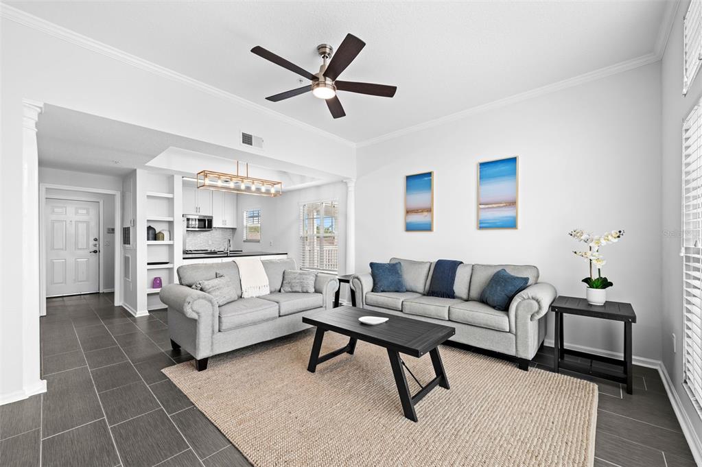 a living room with furniture and a chandelier