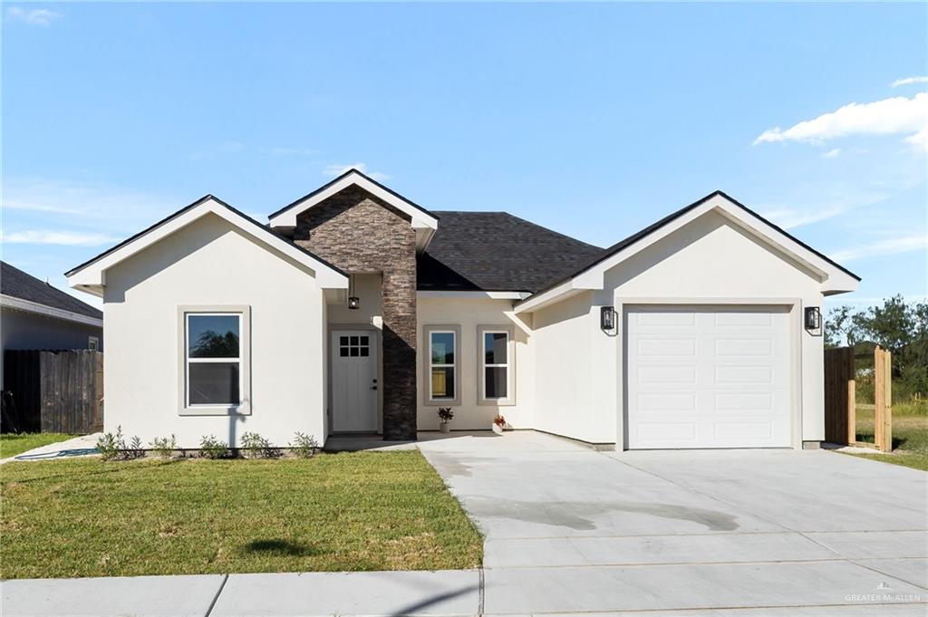 a view of a house with a yard and garage