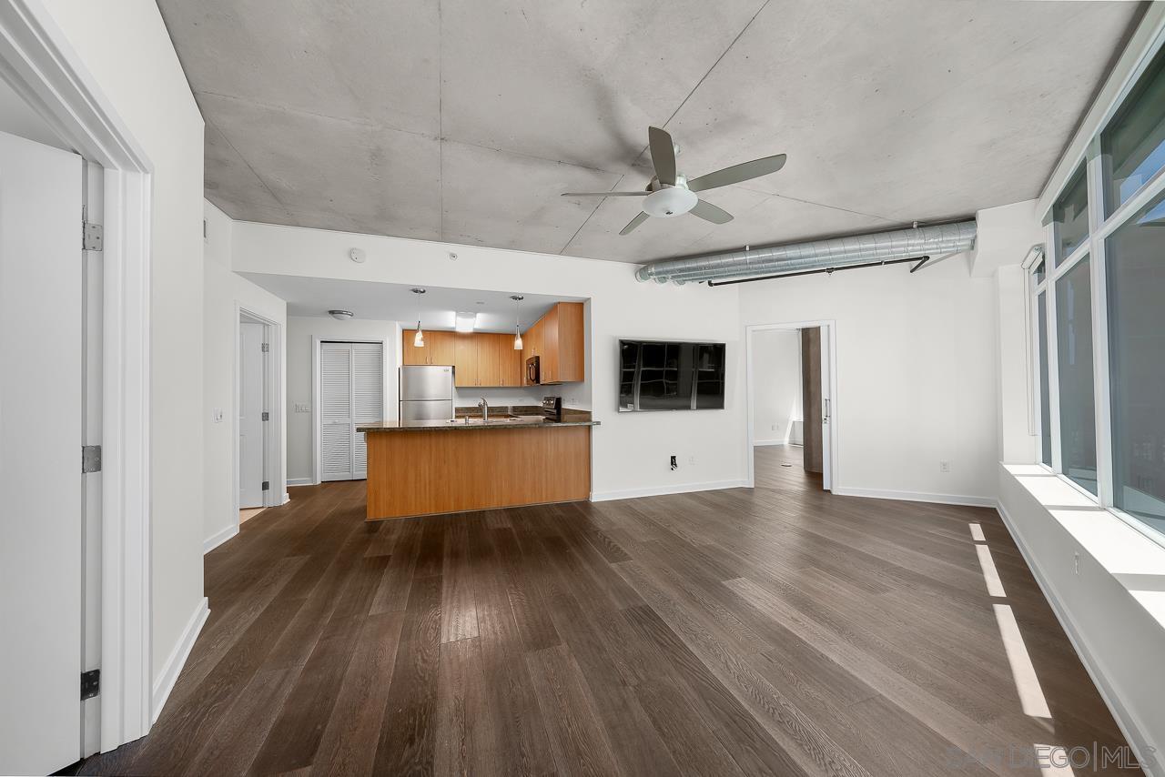 a view of kitchen with microwave and refrigerator