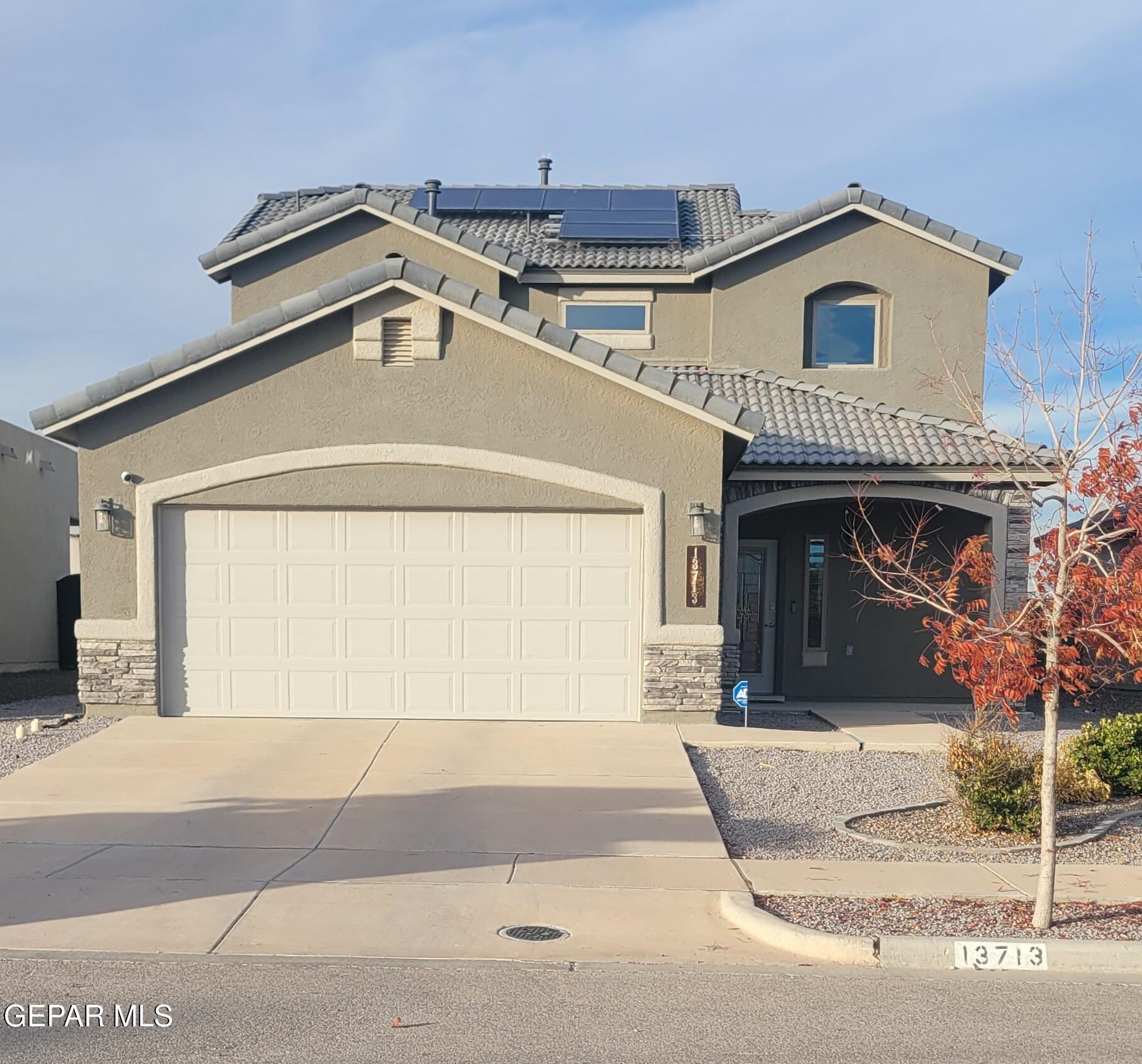 a front view of a house with a garage