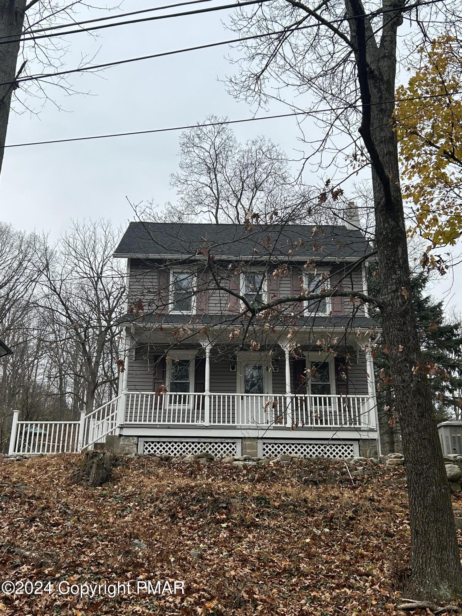 a porch with a bench in front of house