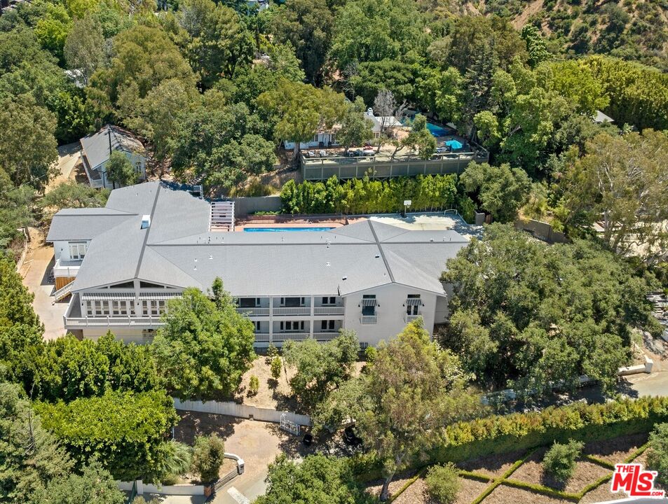 an aerial view of a house with a yard and garden