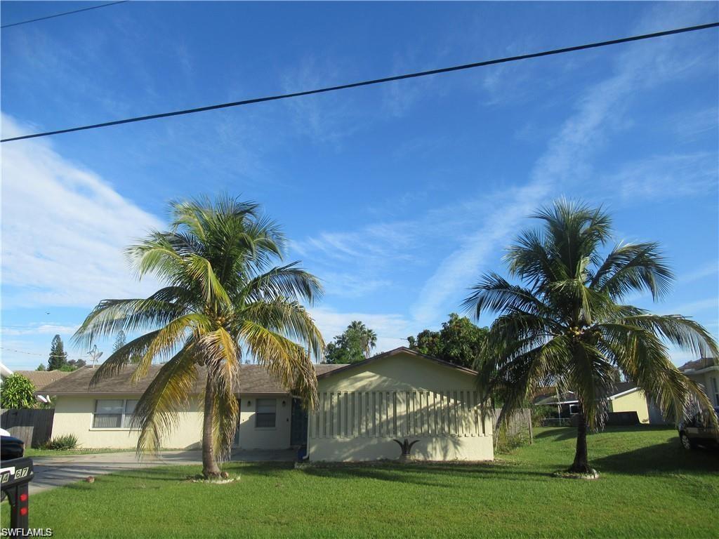 a view of a palm trees front of house