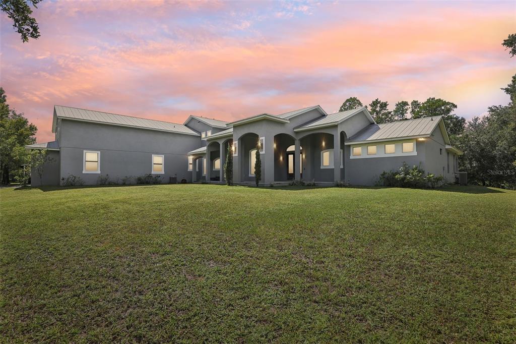 a front view of house with yard and green space