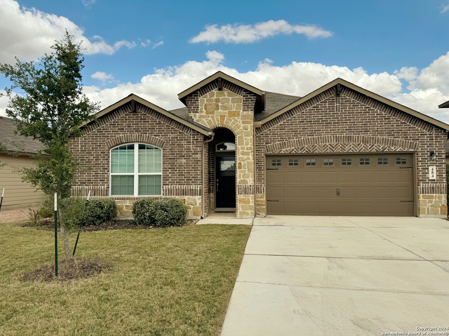 a front view of a house with garage