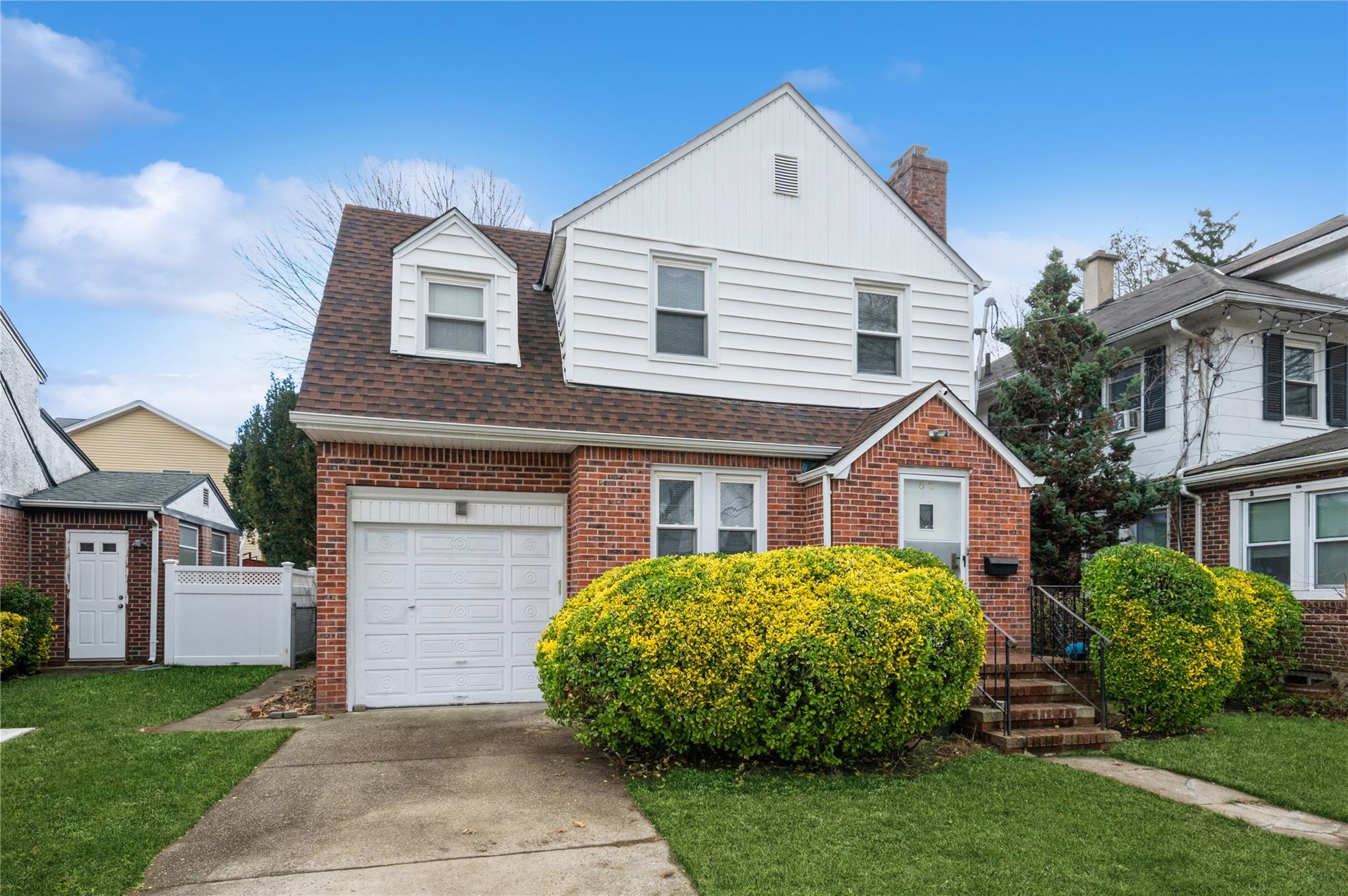 View of front of house featuring a front yard and a garage