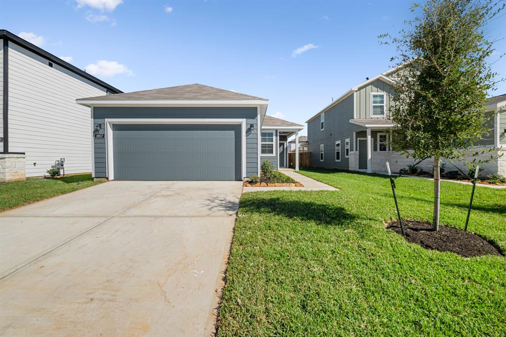 a view of a house with a yard and pathway