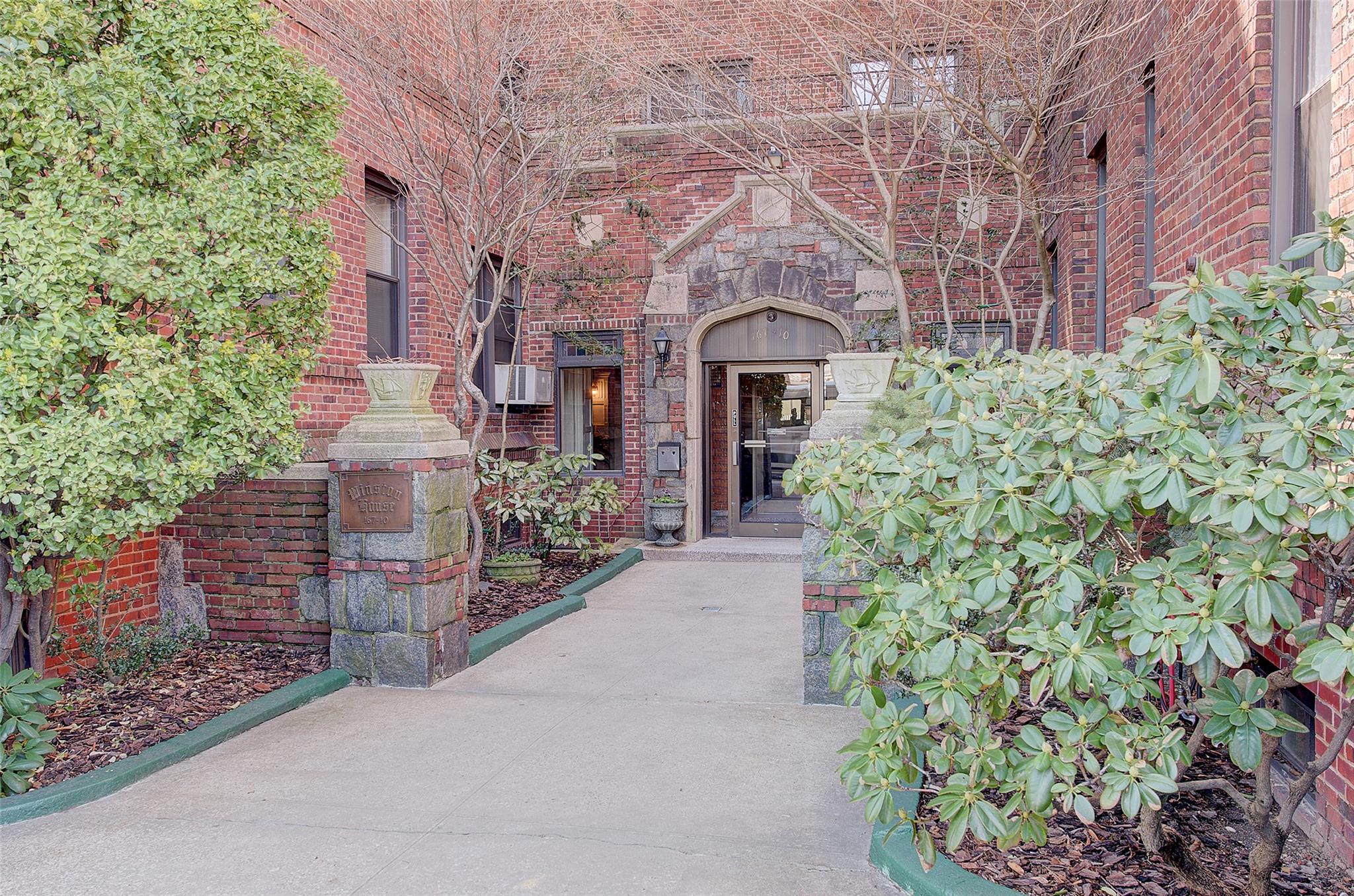 a front view of a building with garden