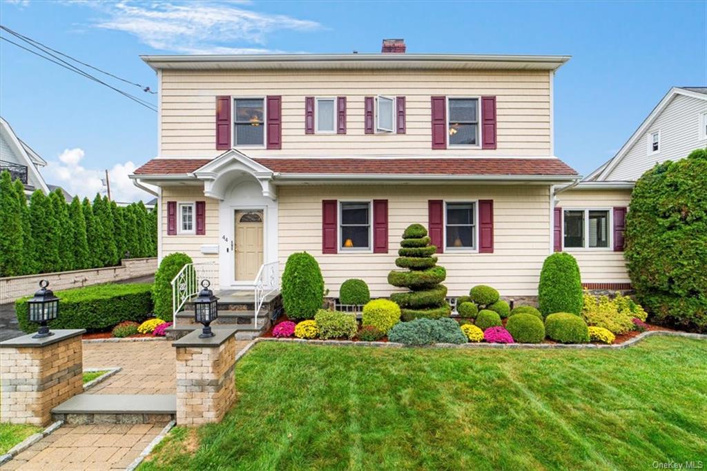 a front view of house with yard and green space