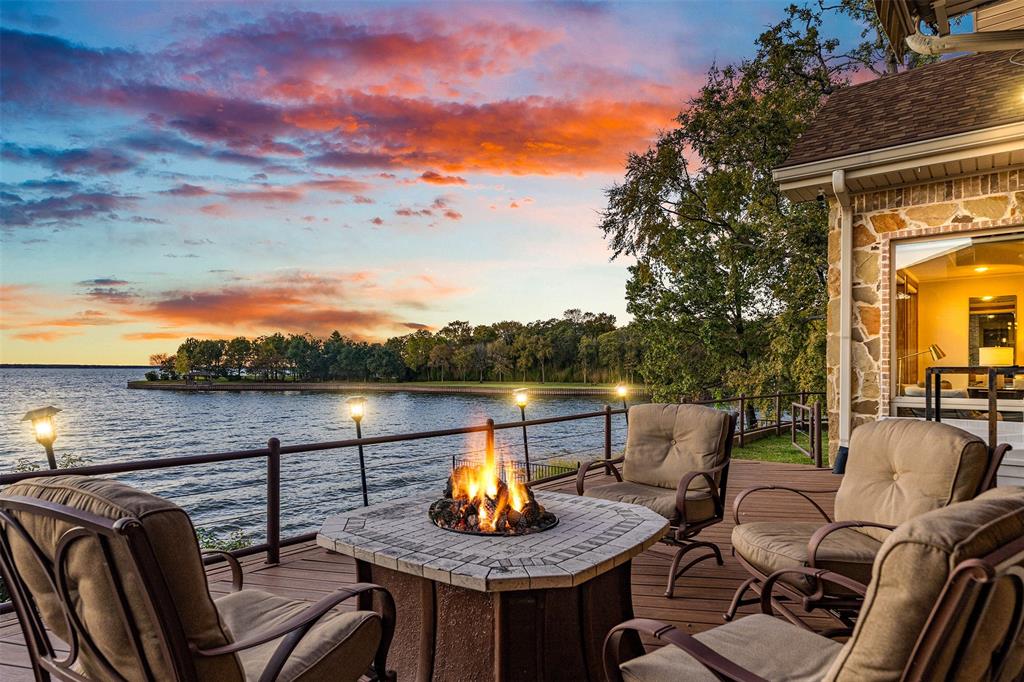 a view of a lake from balcony with furniture